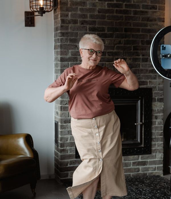 Woman feeling energetic and happy during a light workout at home.